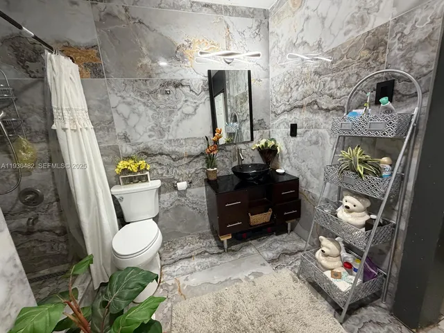 a room with furniture a window and potted plant