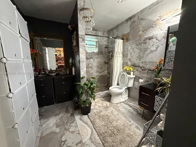 a bathroom with a sink toilet and shower