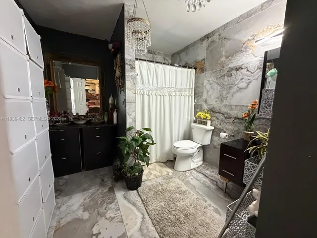 a bedroom with a bed closet and a large window