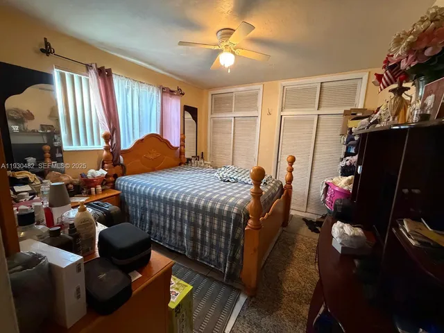 a bedroom with a bed and a couch