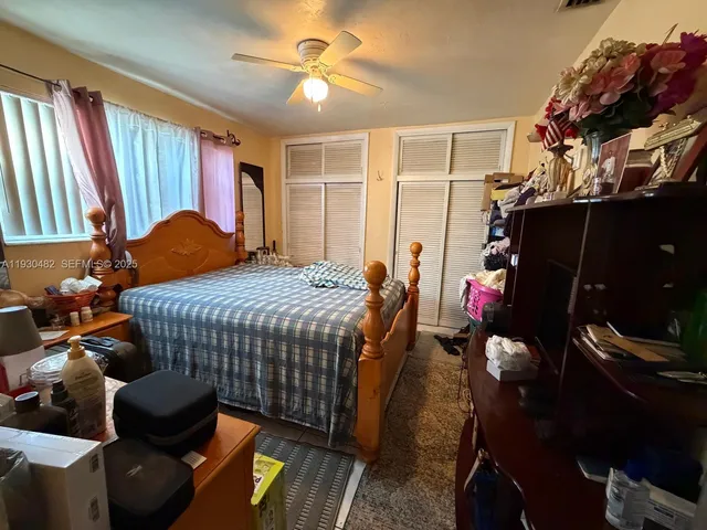 a bedroom with a bed and a mirror