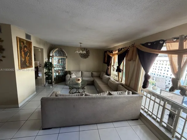 a view of a dining room and livingroom with furniture and window