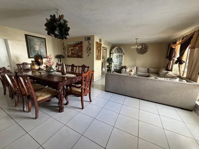 a view of a backyard with plants and a patio