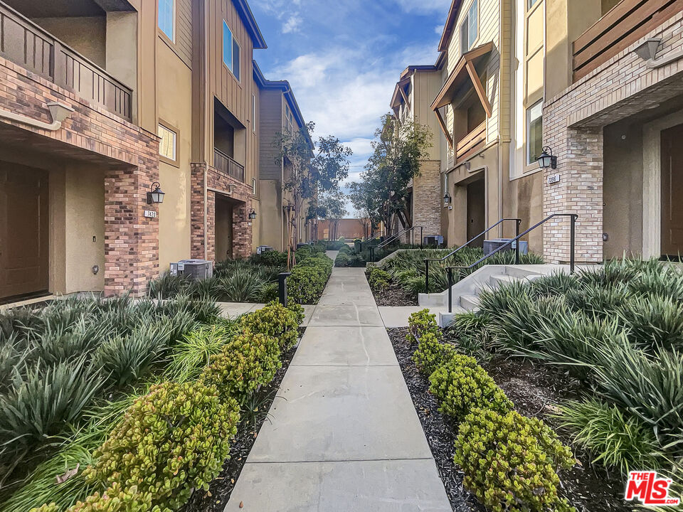 7396 Solstice Place Rancho Cucamonga, CA 91739 - Photo 1 of 18 a view of a pathway both side of house