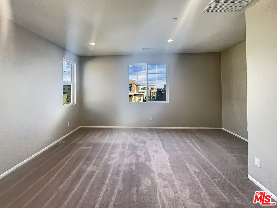 7396 Solstice Place Rancho Cucamonga, CA 91739 - Photo 15 of 18 a view of empty room with wooden floor and fan