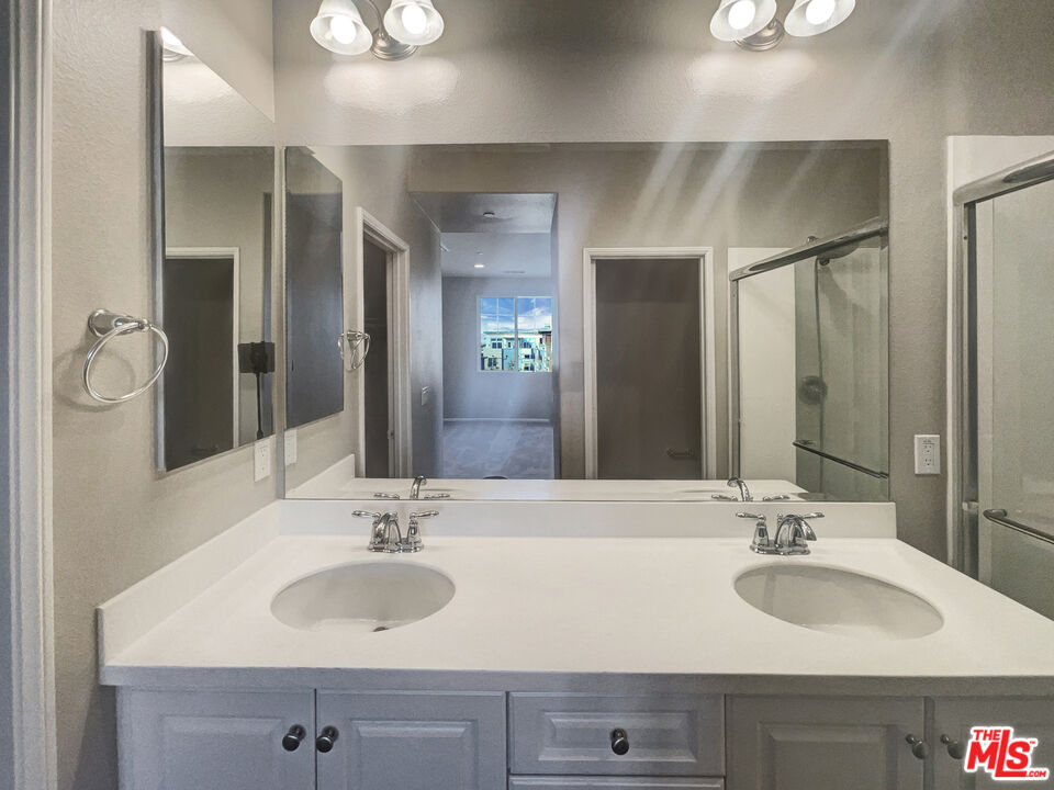 7396 Solstice Place Rancho Cucamonga, CA 91739 - Photo 16 of 18 a bathroom with double sink and a mirror