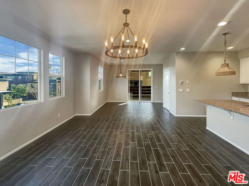 7396 Solstice Place Rancho Cucamonga, CA 91739 - Photo 4 of 18 a view of a room with wooden floor and large windows