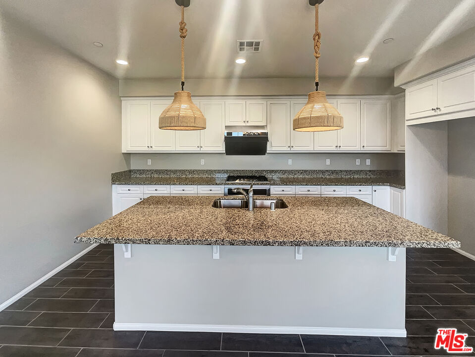 7396 Solstice Place Rancho Cucamonga, CA 91739 - Photo 10 of 18 a kitchen with a sink a counter top space cabinets and stainless steel appliances