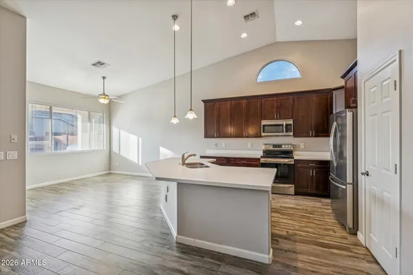 a kitchen with kitchen island a sink stainless steel appliances and cabinets
