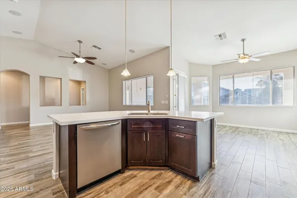 a kitchen with a sink cabinets and wooden floor