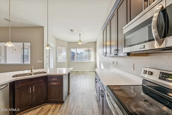 a kitchen with a sink and wooden cabinets
