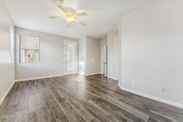 an empty room with wooden floor and a window