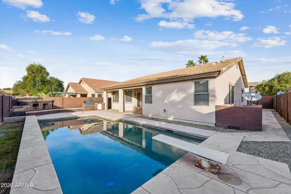 a view of a house with swimming pool and sitting area