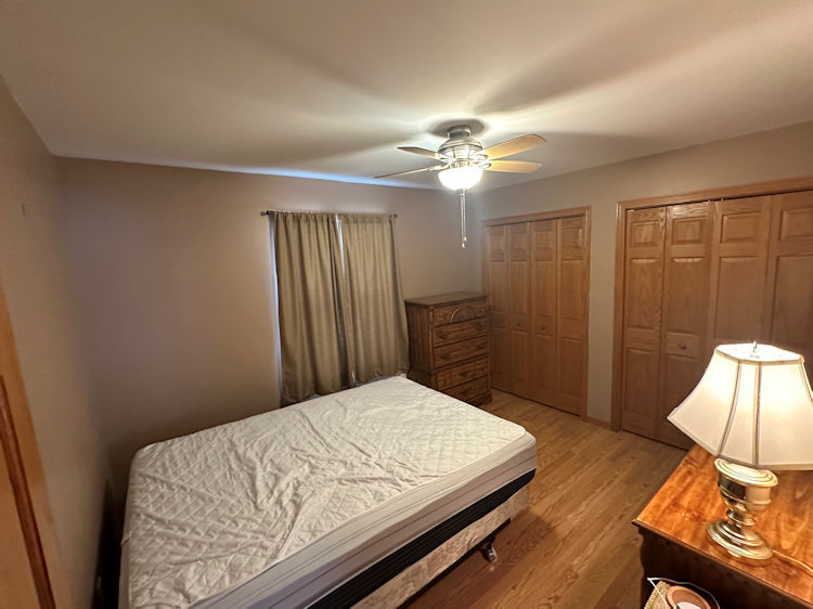 315 6th Avenue Rochelle, IL 61068 - Photo 7 of 11 a bedroom with a bed and a chandelier