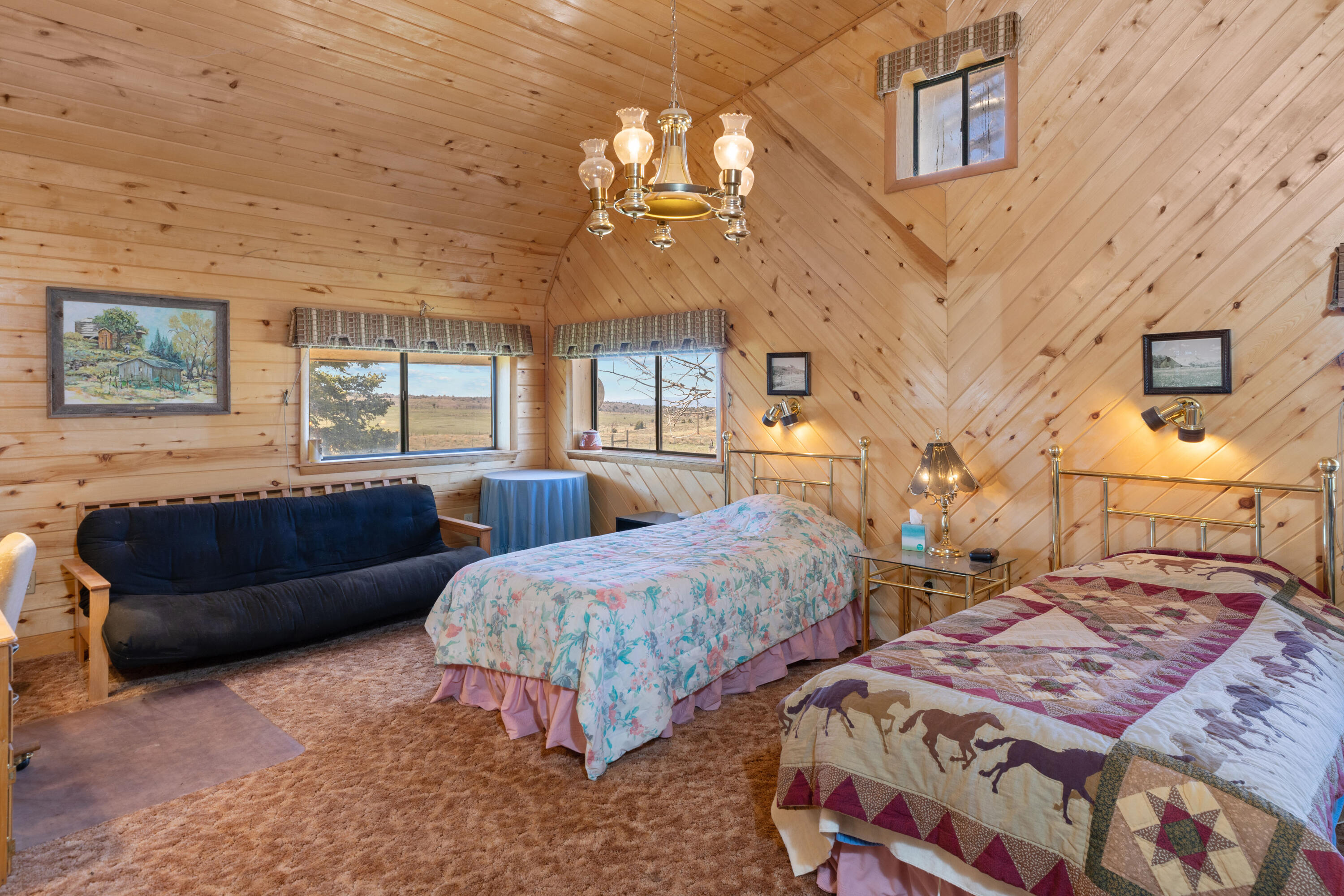 1692 County Road Placerville, CO 81430 - Photo 15 of 36 a spacious bedroom with two beds and a chandelier