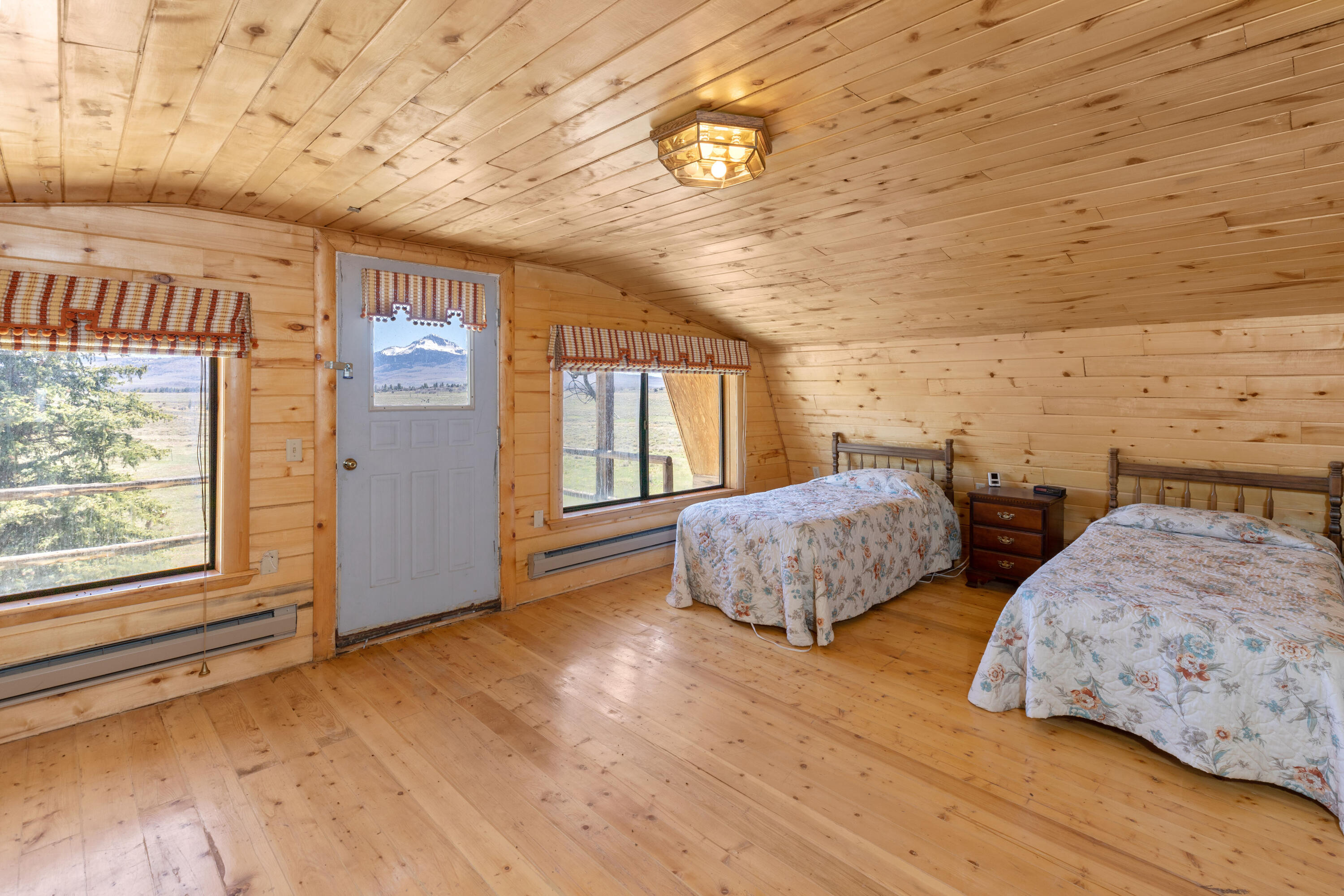 1692 County Road Placerville, CO 81430 - Photo 17 of 36 a bedroom with two beds and a window