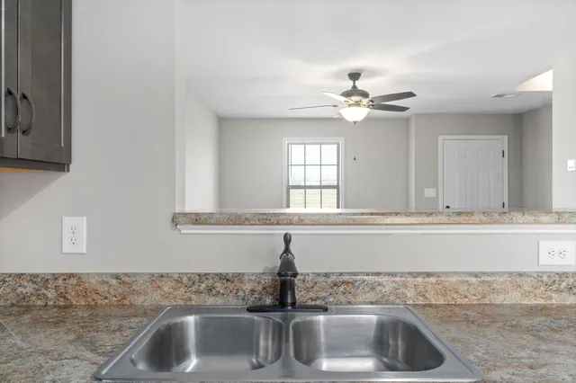 a kitchen with a sink and chandelier