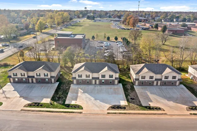 an aerial view of residential houses with city view