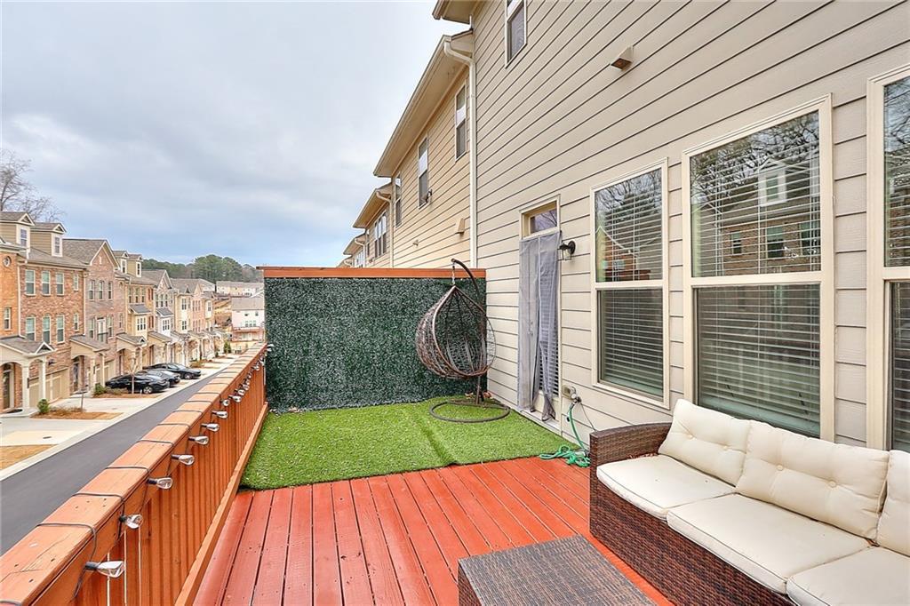 1306 Harris Way South Atlanta, GA 30319 - Photo 16 of 19 a view of a balcony with floor to ceiling windows with wooden floor