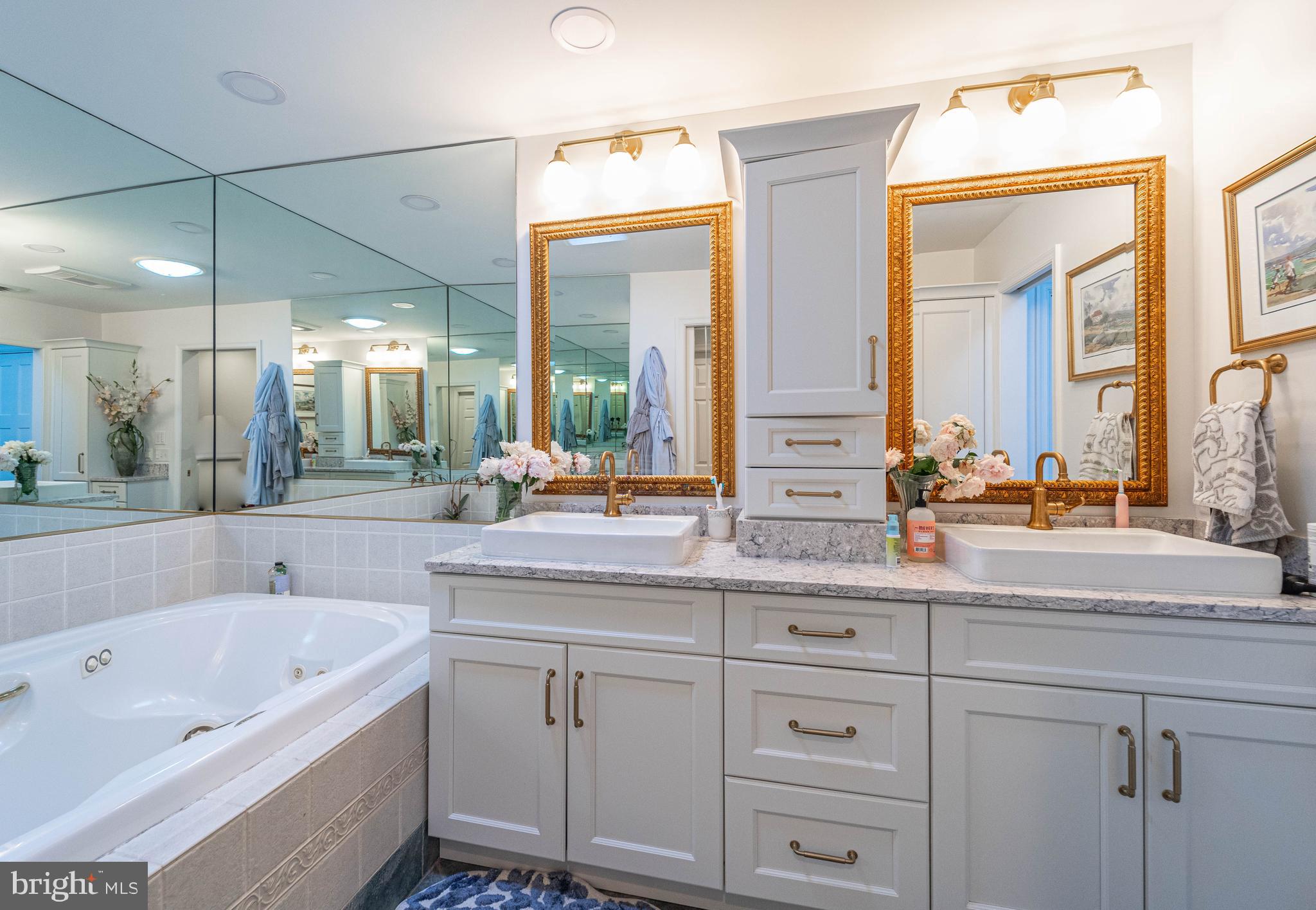 605 St Francis Road Baltimore, MD 21286 - Photo 33 of 56 a bathroom with a tub a double vanity sink and a large mirror