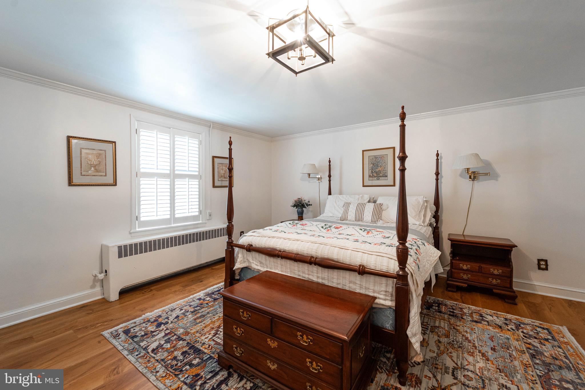 605 St Francis Road Baltimore, MD 21286 - Photo 44 of 56 a bedroom with a bed a dresser and wooden floor