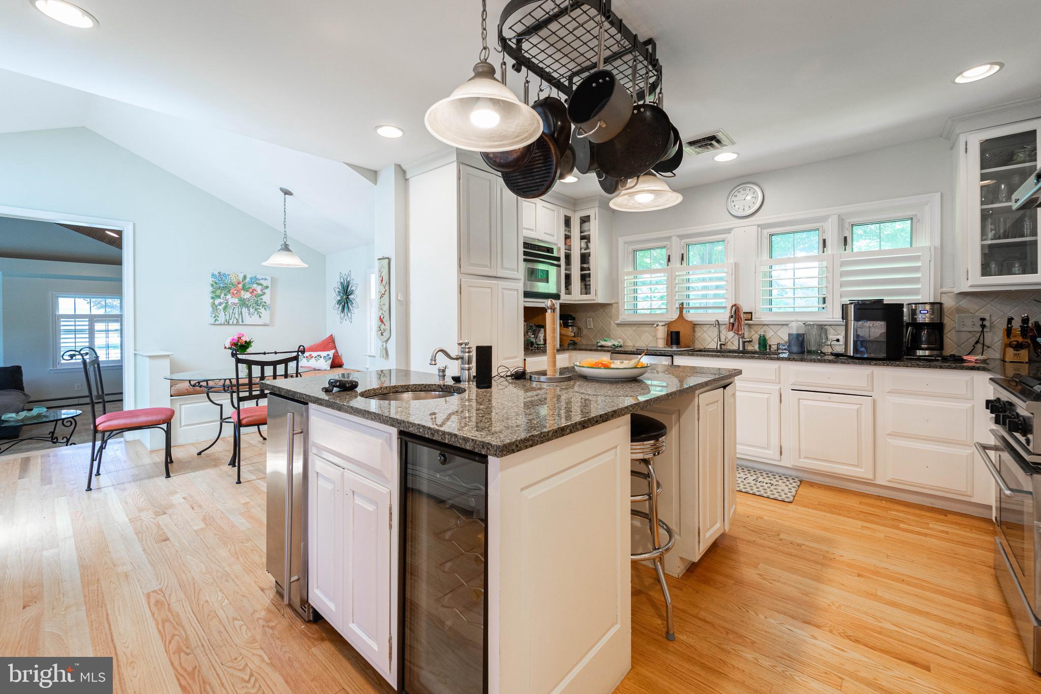 605 St Francis Road Baltimore, MD 21286 - Photo 47 of 56 a kitchen with stainless steel appliances granite countertop a stove a sink dishwasher a dining table and chairs with wooden floor