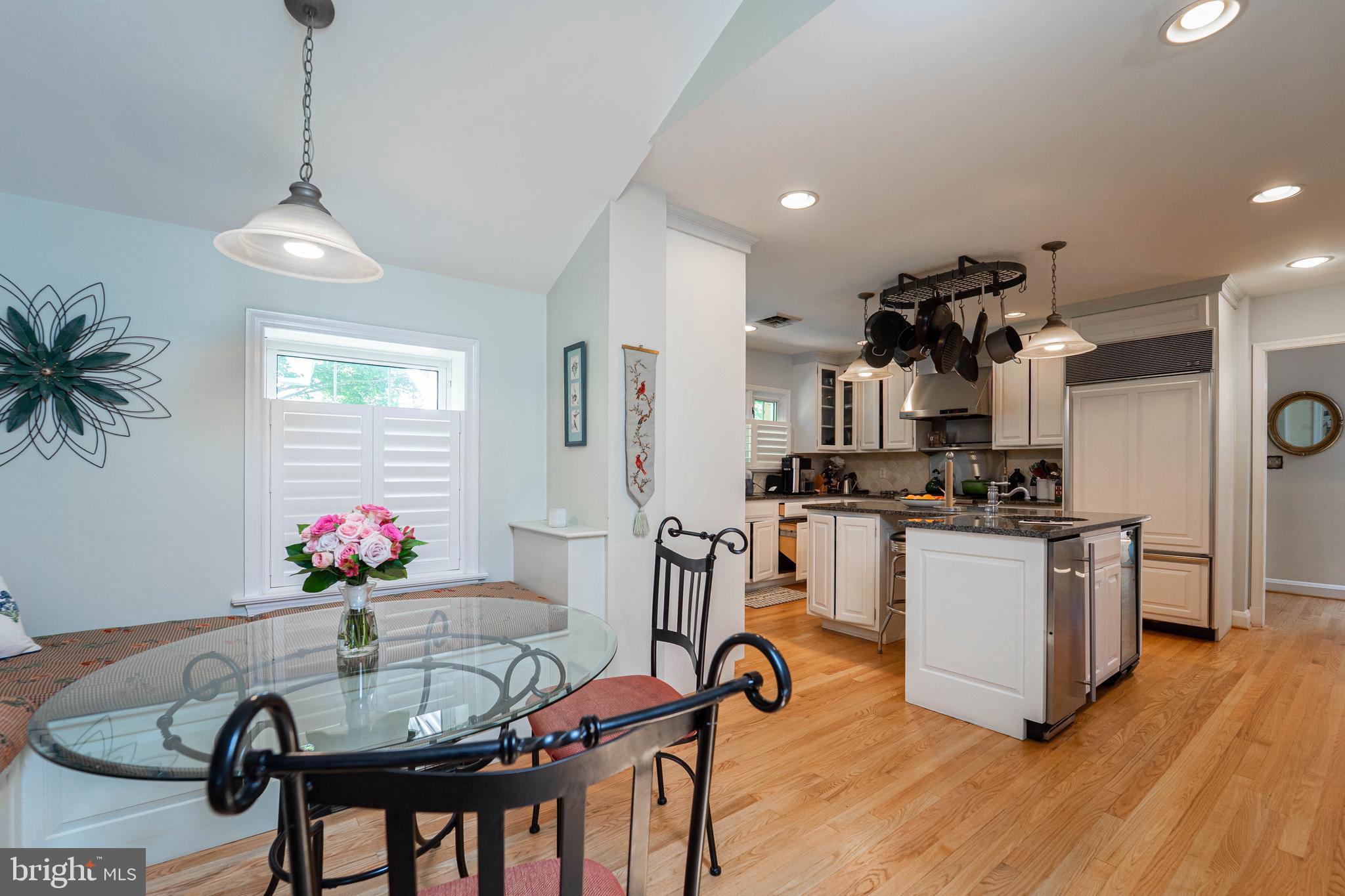 605 St Francis Road Baltimore, MD 21286 - Photo 49 of 56 a kitchen with stainless steel appliances kitchen island granite countertop a dining table chairs stove and white cabinets