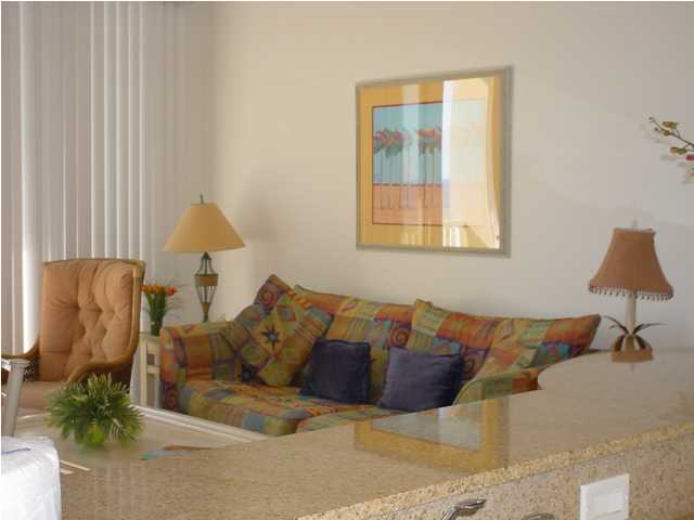 590 Santa Rosa Boulevard, Unit 213 Fort Walton Beach, FL 32548 - Photo 2 of 9 a living room with furniture and a lamp