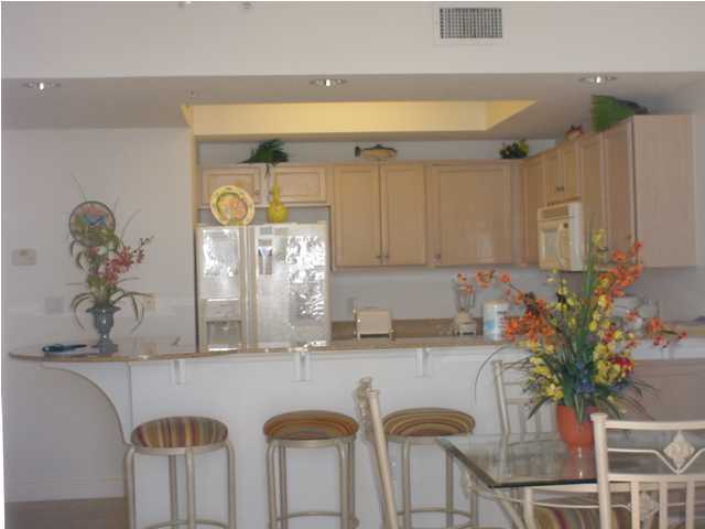590 Santa Rosa Boulevard, Unit 213 Fort Walton Beach, FL 32548 - Photo 4 of 9 a kitchen with table and chairs in it