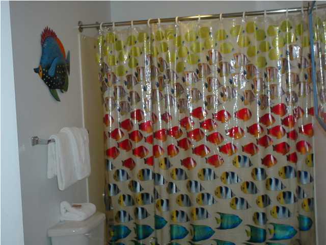 590 Santa Rosa Boulevard, Unit 213 Fort Walton Beach, FL 32548 - Photo 8 of 9 a bathroom with a shower curtain and a curtain