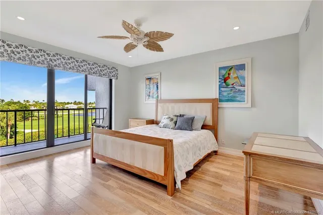 a bedroom with a large bed and a large window