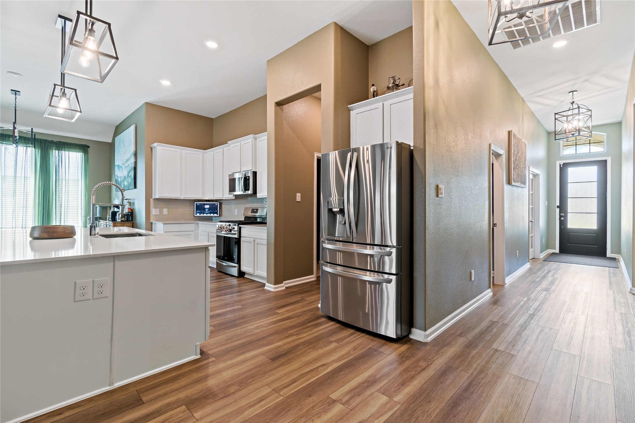 4403 Annandale Lane Rosharon, TX 77583 - Photo 14 of 48 a kitchen with stainless steel appliances a refrigerator and wooden floor