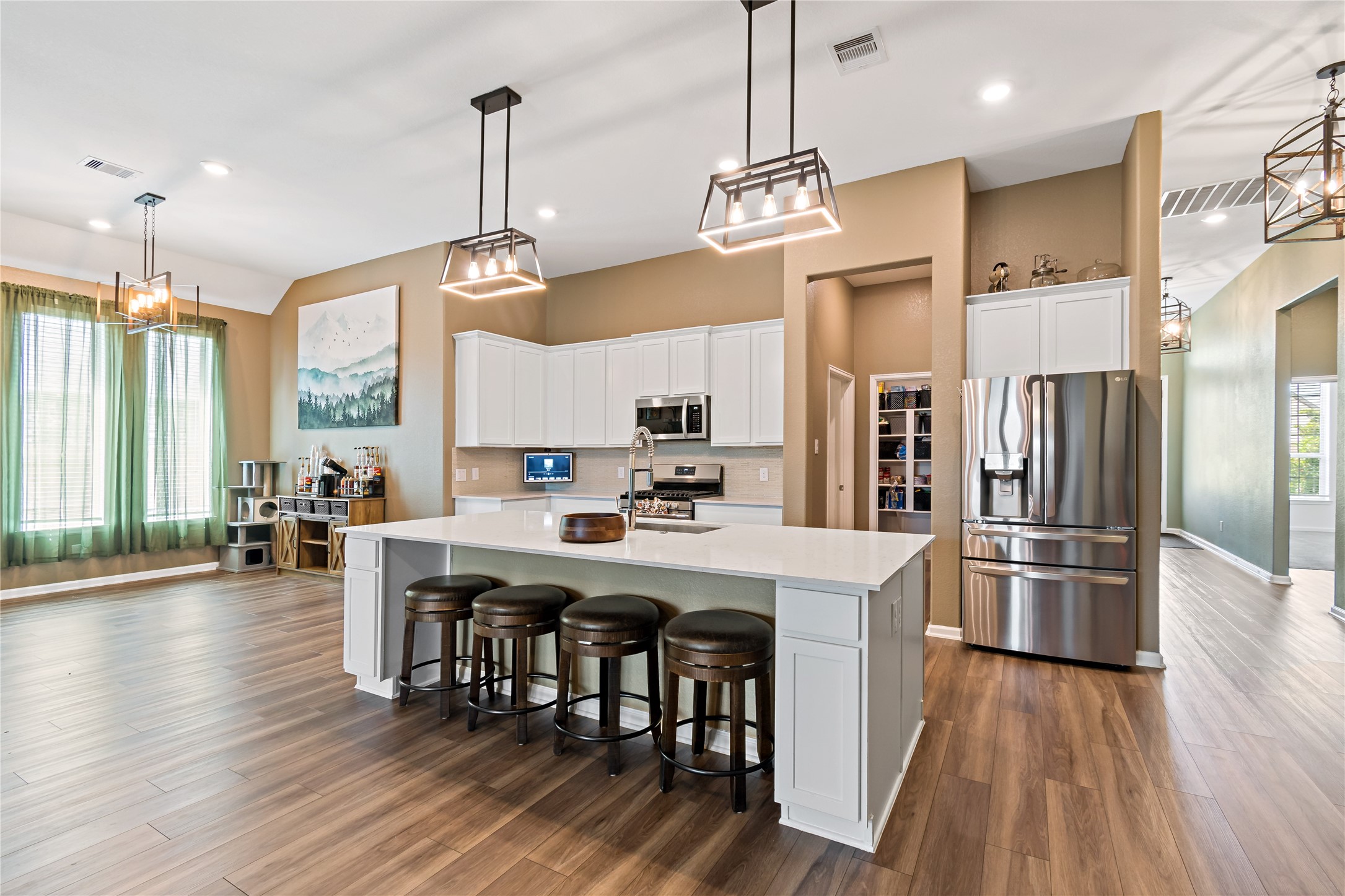 4403 Annandale Lane Rosharon, TX 77583 - Photo 17 of 48 a kitchen with stainless steel appliances a dining table chairs stove refrigerator and cabinets