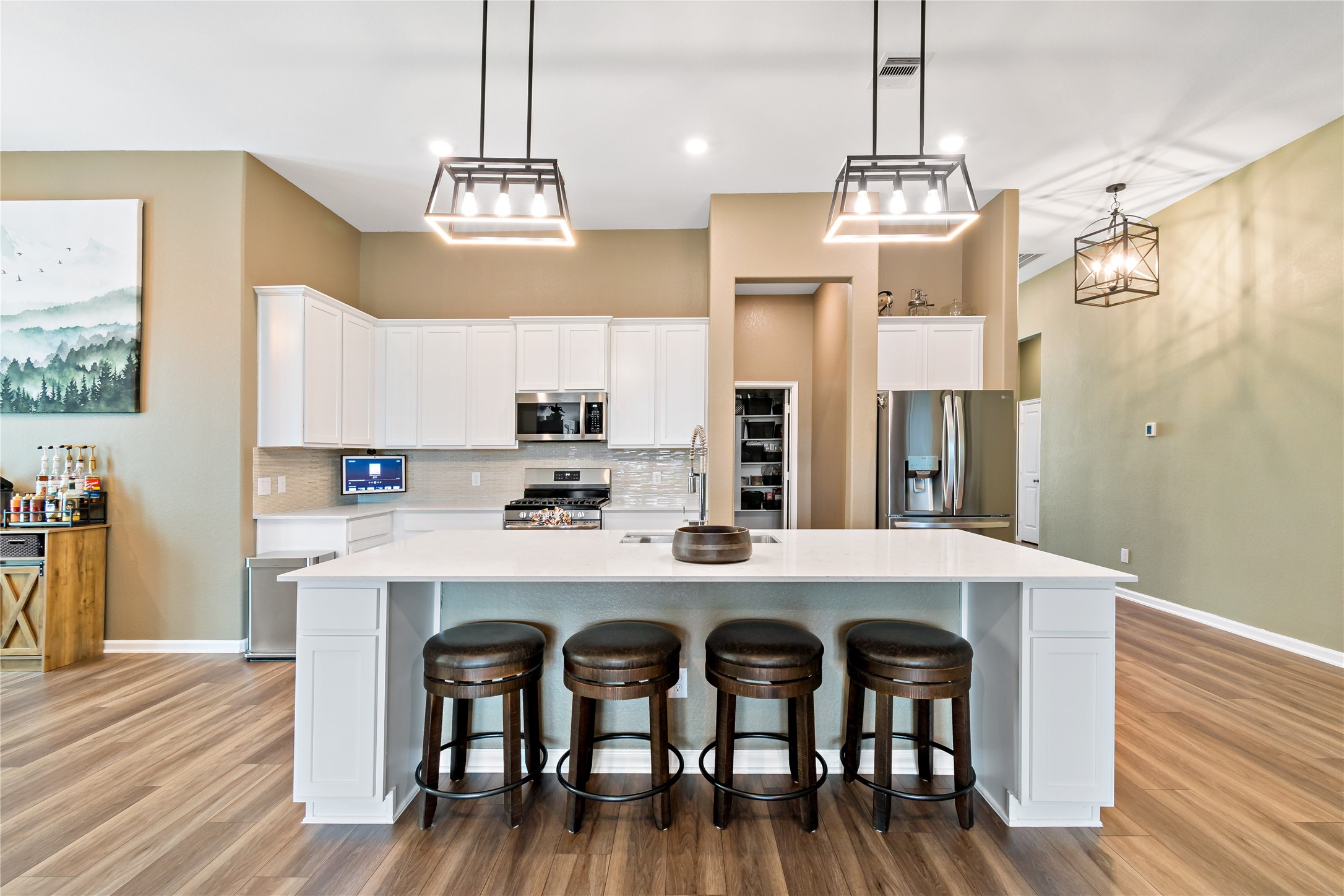 4403 Annandale Lane Rosharon, TX 77583 - Photo 19 of 48 a kitchen with stainless steel appliances a dining table chairs sink and wooden floor