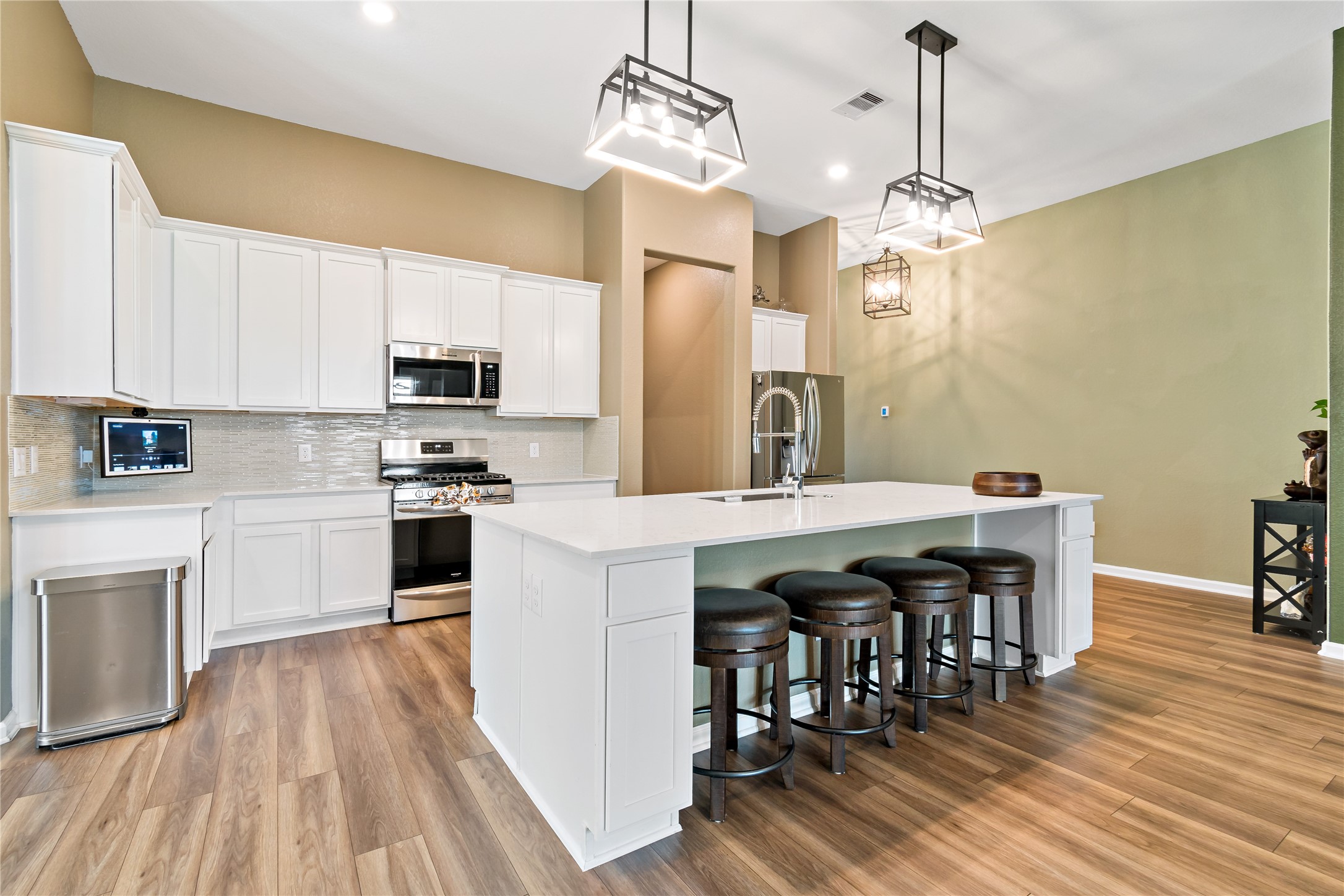 4403 Annandale Lane Rosharon, TX 77583 - Photo 20 of 48 a kitchen with stainless steel appliances a dining table chairs stove and sink