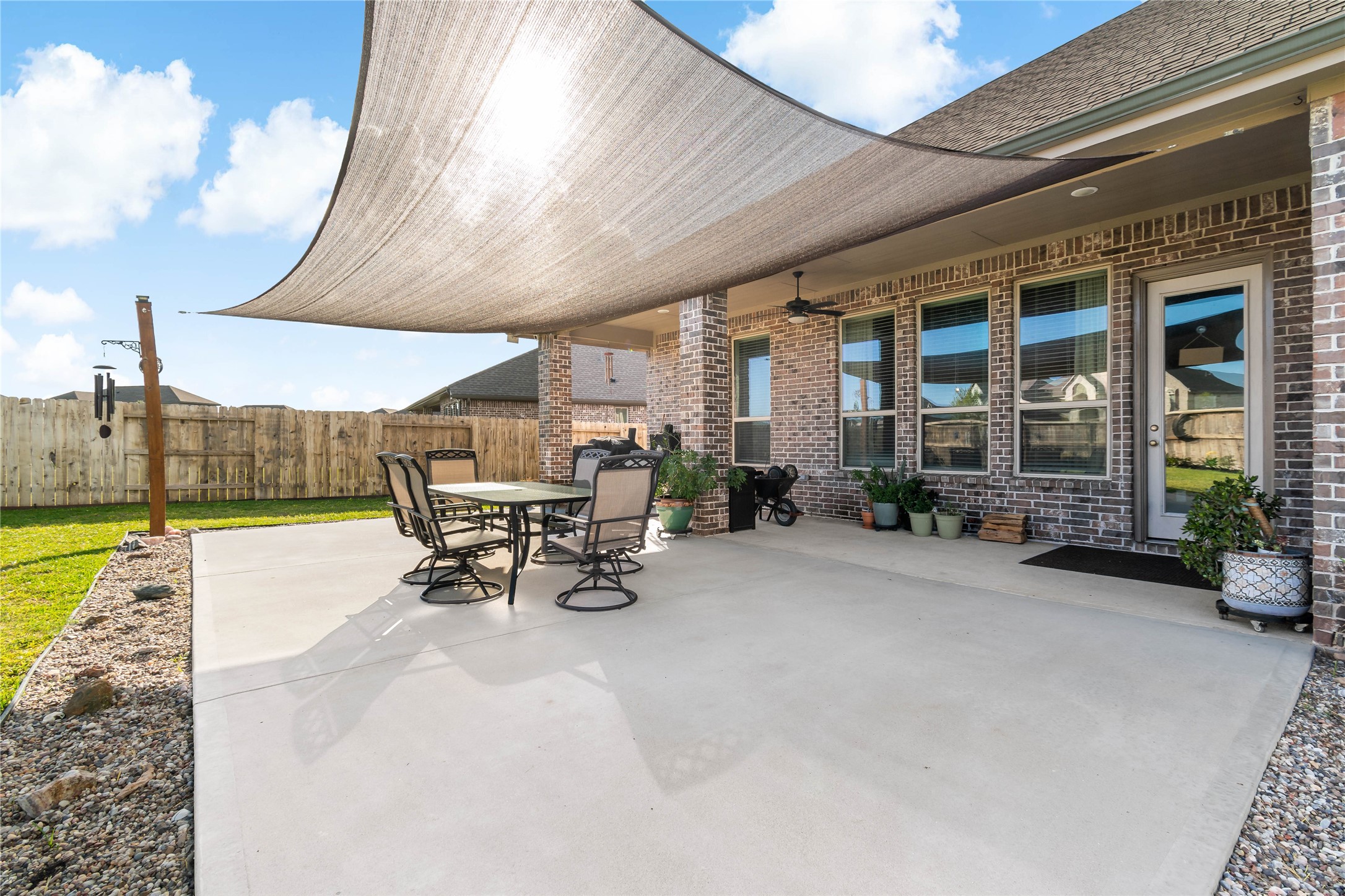 4403 Annandale Lane Rosharon, TX 77583 - Photo 38 of 48 a view of a patio with table and chairs under an umbrella with a barbeque
