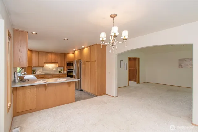 a view of a kitchen with a sink stainless steel appliances and cabinets