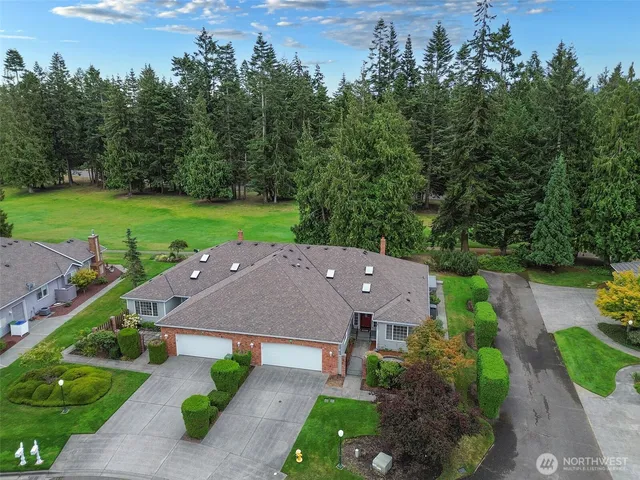 an aerial view of a house with garden space and a street view