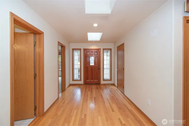 a view of hallway with wooden floor