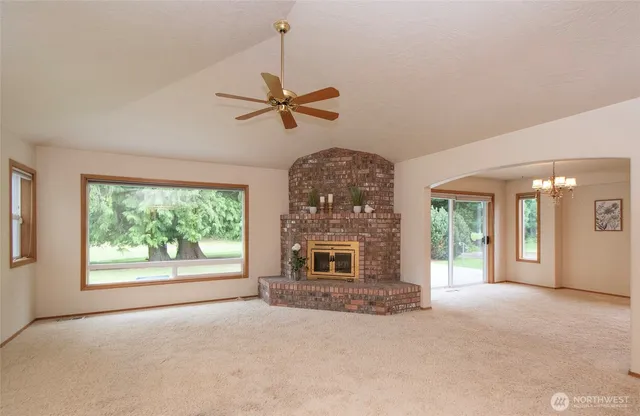 a view of a livingroom with a ceiling fan and window