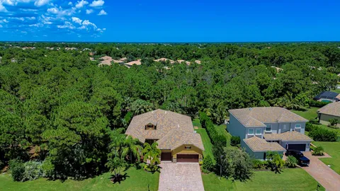 an aerial view of a house with yard and outdoor seating