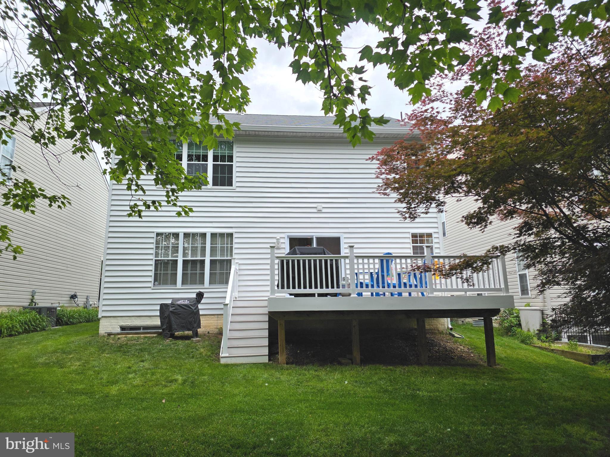 2441 Kemper Road Crofton, MD 21114 - Photo 25 of 63 a front view of a house with a garden and deck