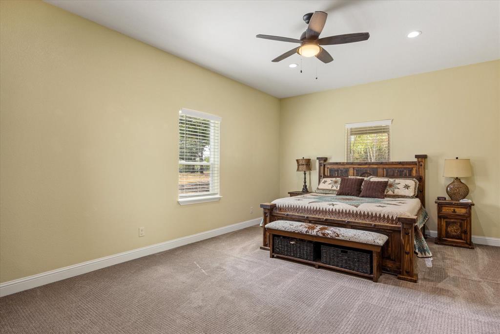 9739 Waldrup Road Lipan, TX 76462 - Photo 17 of 38 Large primary bedroom has plenty of room for all of your furniture.