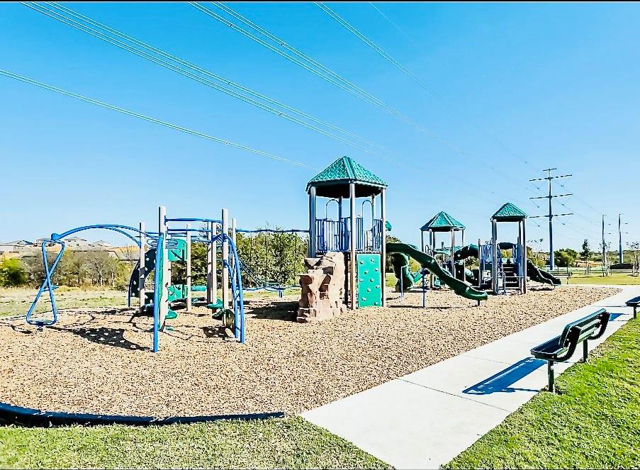 196 Cattlemans Crk Road West Newark, TX 76071 - Photo 29 of 31 One of Two Community playground featuring multiple play structures with slides, climbing elements, and swings