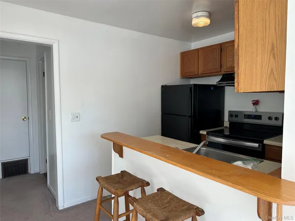 a kitchen with a sink and a refrigerator