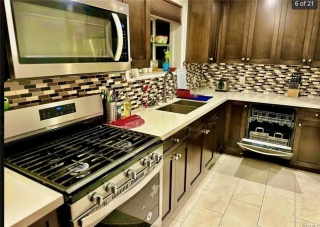 a kitchen with stove and cabinets