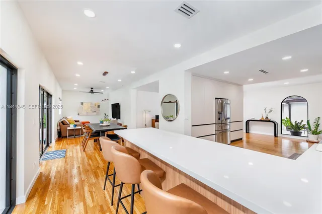 a view of a dining hall with a dining table chairs and couches