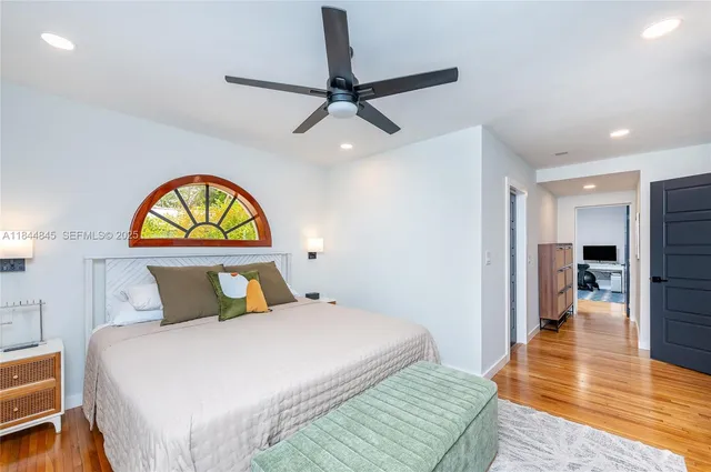 a bedroom with a bed and a television