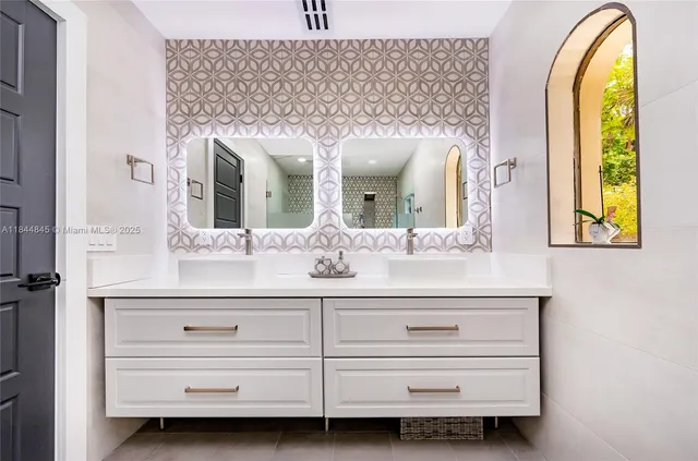 a bathroom with a sink mirror and window