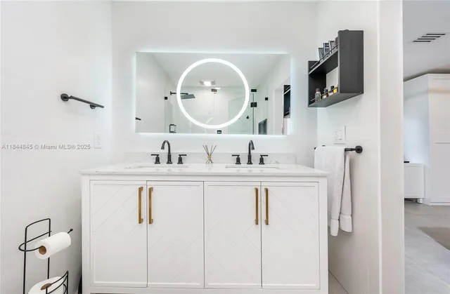 a bathroom with a double vanity sink and a mirror
